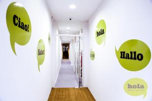 a hallway that has a bunch of different colored walls at Hola Hostal Eixample in Barcelona