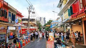 a group of people walking down a street in a city at CU iHouse เรือนวิรัชมิตร in Bang Rak