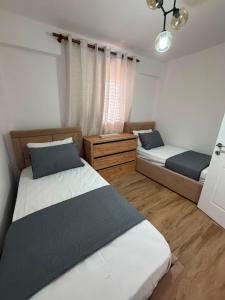 a bedroom with two beds and a window at The Canyon House in Çuadar