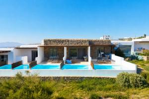 a villa with a view of the swimming pool at Aegean Hospitality in Mikonos