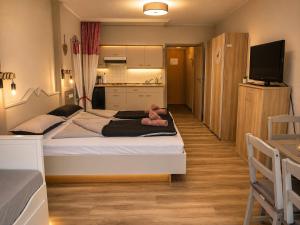 a bedroom with two beds with a teddy bear sitting on them at Ferienwohnung Darosa Alpenliebe in Seeg