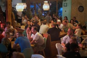 a large crowd of people sitting in a restaurant at Camping 2000 in Januv Dul +126 photos