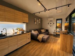 a kitchen and a living room with a couch at Domki Na Talerzu in Skorochow