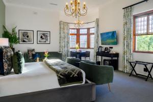a bedroom with a large bed and a desk at Palm House Boutique Hotel and Spa in Cape Town