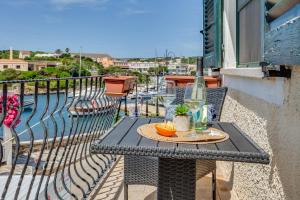 a table on a balcony with a bottle of wine at Blue Horizon Stintino in Stintino