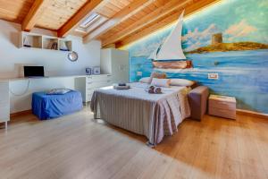 a bedroom with a bed with a painting on the wall at Blue Horizon Stintino in Stintino