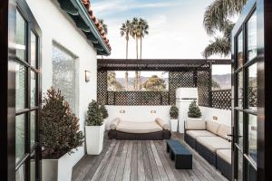 a living room with a couch and a table at Montecito Inn in Santa Barbara