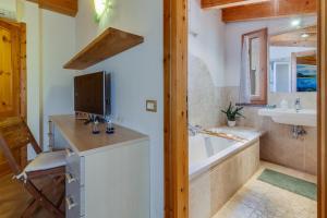 a bathroom with a tub and a sink at Blue Horizon Stintino in Stintino +39 photos