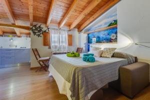 a bedroom with a large bed in a room with wooden ceilings at Blue Horizon Stintino in Stintino