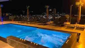 a swimming pool on top of a building at night at Hotel Selavi in Sarandë