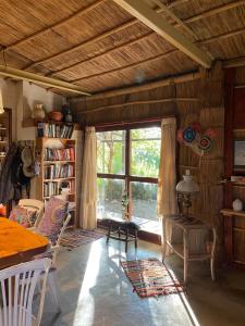 a living room with a table and a large window at Gran Cabaña con parque en Catamarca in San Fernando del Valle de Catamarca +16 photos