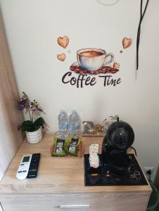 a table with a coffee time sign on a wall at Clausis in Parghelia