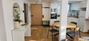 a kitchen and dining room with a table and chairs at Casa dos Azevedos in Câmara de Lobos +3 photos