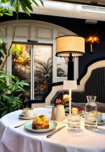 a table with a plate of food on it at The Leo Grand in Vienna