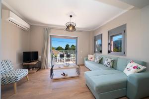 a living room with a couch and a table at K for Kefalonia in Karavomylos