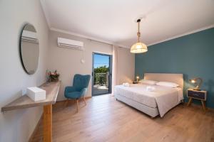 a bedroom with a bed and a mirror and a chair at K for Kefalonia in Karavomylos
