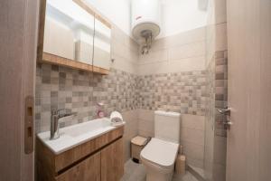 a bathroom with a white toilet and a sink at K for Kefalonia in Karavomylos +53 photos