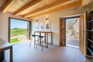 a kitchen with a table and chairs and a large window at Agriturismo Monte Bisson - Piscina Privata in Soave