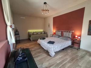 a large bedroom with a bed and a couch at Ca' della Civetta in Gavedo