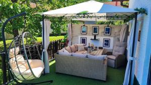 a gazebo with couches and a swing at Zagora Hills Premium Apartman in Krapina