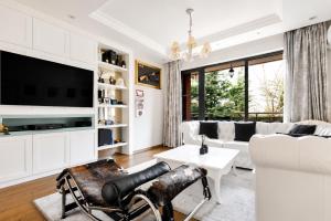 a living room with white furniture and a tv at Top 10 3BR2BH Jacuzzi Free Parking in Sofia
