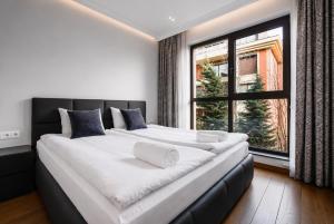 a large bed in a room with a large window at Top 10 3BR2BH Jacuzzi Free Parking in Sofia +46 photos