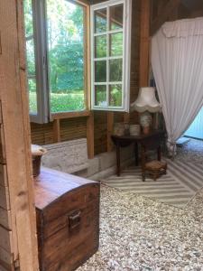 a room with a table and windows and a desk at Dortoir en charente in Jarnac
