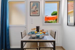 a dining room with a table and chairs and a window at chambre d'hôtes des bleuets in Saint-Firmin-des-Prés +16 photos