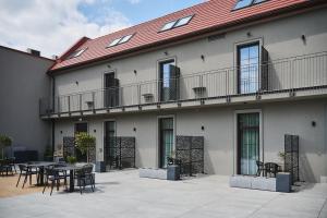 a patio with tables and chairs in front of a building at Hotel Zator in Zator
