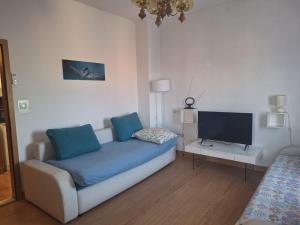 a living room with a couch and a flat screen tv at Hana Apartments in Zadar