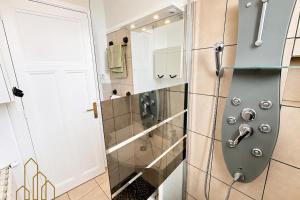 a bathroom with a shower with a glass door at L'Esprit Descartes in Roanne