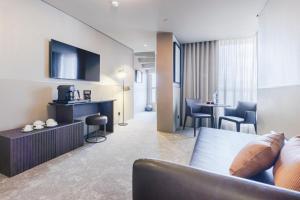 a living room with a couch and a table at Hotel White Lisboa in Lisbon
