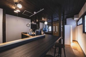 a kitchen with a counter and a refrigerator at Hidasumika Ojin AN in Takayama +20 photos