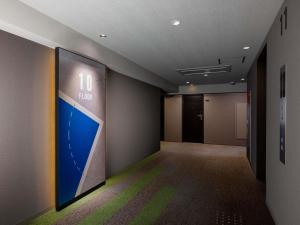 an office hallway with a large sign on the wall at ibis Budget Osaka Umeda in Osaka