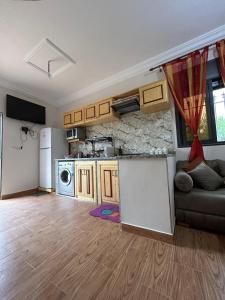a kitchen and a living room with a couch in a room at DAR Assoul in Khenifra