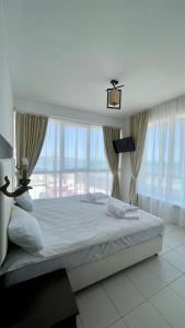 a bedroom with a large bed with a large window at Отель у моря Chester in Odesa