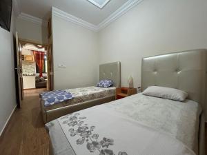 a bedroom with two beds and a mirror at DAR Assoul in Khenifra