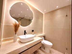a bathroom with a sink and a toilet and a mirror at Hotel Quinta de Cabecera in Bucaramanga +33 photos