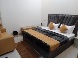 a bedroom with a large bed with pillows on it at Swayambhu Hotel in Rudraprayāg