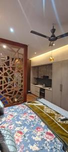 a living room with a kitchen and a room with a bed at Darshana Studios#Galaxyblue sapphire#Stylish in Ghaziabad +18 photos