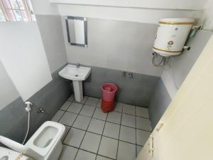 a small bathroom with a sink and a toilet at Swayambhu Hotel in Rudraprayāg +37 photos