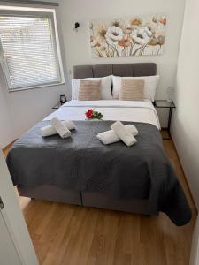 a bedroom with a large bed with two pillows at Matea in Plomin