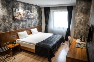 a hotel room with a bed and a window at Newway Otel in Kayseri