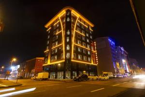 a lit up building on a city street at night at Newway Otel in Kayseri