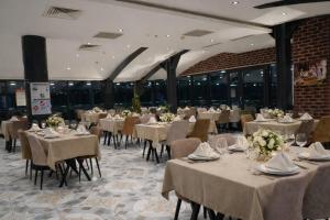 a banquet hall with tables and chairs with white tablecloths at Newway Otel in Kayseri