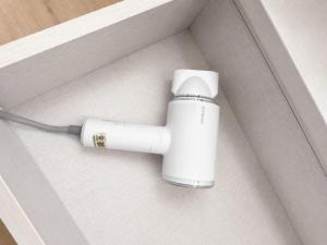 a white device in a box on the floor at Lawson Inn in Sibu