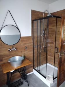 a bathroom with a sink and a shower with a mirror at Siedlisko Jelonki in Urowo +52 photos