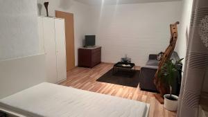 a living room with a bed and a couch at Ruhige Fewo Hinzweiler in Hinzweiler