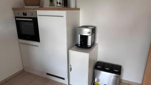 a kitchen with a coffee maker on top of a refrigerator at Ruhige Fewo Hinzweiler in Hinzweiler