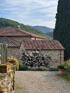 a stone house with flowers in front of it at Resort La noce di Francesca in Londa